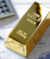 Gold bullion barr on a stocks and shares chart